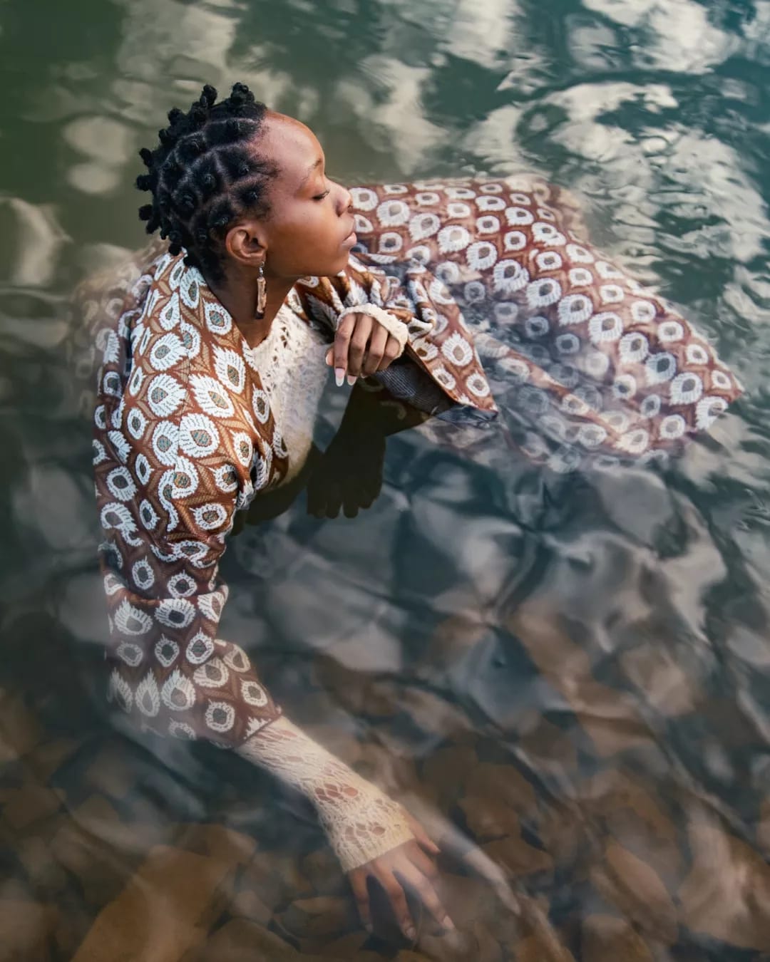 Ande Mafenuka wardrobe styling — BALANCE editorial, model in African-print garment reclining in water