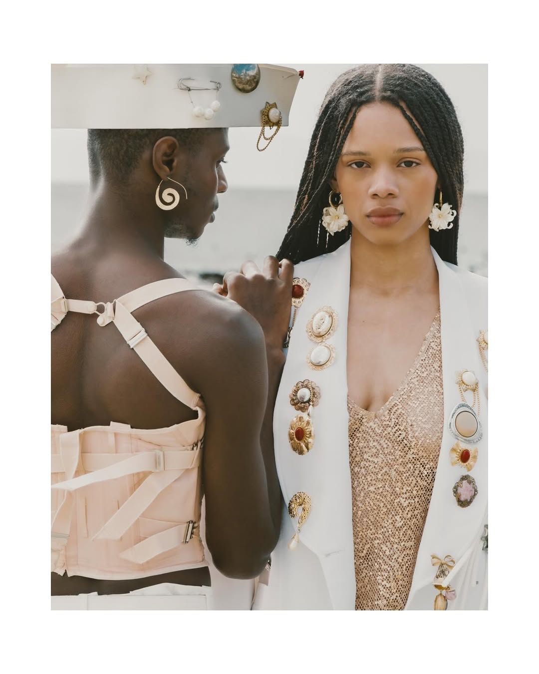 Ande Mafenuka styling — Aesthetics editorial, two models in brooch-laden white blazer and corset