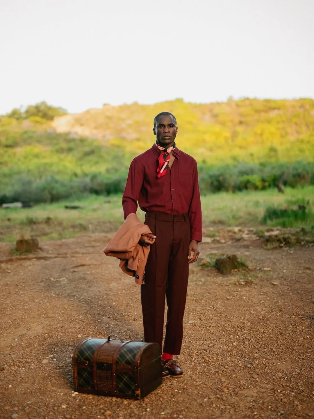 Ande Mafenuka menswear styling — The Old Money Look, burgundy tailoring with travel trunk